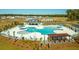 Aerial view of a community pool with ample seating, umbrellas, and a cabana area at 297 Blue Haw Dr, Moncks Corner, SC 29461