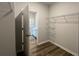 Walk-in closet with wire shelving system and full bath beyond at 297 Blue Haw Dr, Moncks Corner, SC 29461