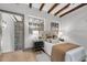 Bedroom with exposed wooden ceiling beams and brick accent wall at 3 Queen St # 315, Charleston, SC 29401
