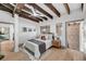 Comfortable bedroom featuring exposed brick, wood beams, and neutral tones at 3 Queen St # 315, Charleston, SC 29401