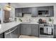 Contemporary kitchen boasts stainless appliances, stone counter tops, and modern cabinetry at 3 Queen St # 315, Charleston, SC 29401