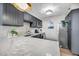 Modern kitchen featuring marble countertops, stainless steel appliances, and sleek gray cabinetry at 3 Queen St # 315, Charleston, SC 29401