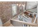 Open concept living room featuring hardwood floors, brick wall, and modern furniture at 3 Queen St # 315, Charleston, SC 29401