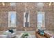 Spacious living room with exposed brick wall, large windows, and stylish contemporary furnishings at 3 Queen St # 315, Charleston, SC 29401
