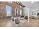 Bright and airy living room with exposed brick and high ceilings at 3 Queen St # 315, Charleston, SC 29401