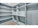An organized walk-in closet with ample shelving and hanging rods at 3 Queen St # 315, Charleston, SC 29401