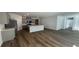 Open-concept kitchen and living area featuring gray cabinets, stainless steel appliances, and wood-look floors at 302 Blue Haw Dr, Moncks Corner, SC 29461