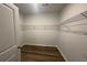 Walk-in closet with wire shelving and wood look flooring at 302 Blue Haw Dr, Moncks Corner, SC 29461