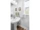 Bright bathroom featuring a pedestal sink, stylish fixtures, and a window with natural light at 307 Lanyard St, Johns Island, SC 29455