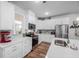 Modern kitchen with stainless steel appliances, white cabinets, and granite countertops at 307 Lanyard St, Johns Island, SC 29455