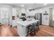 Bright kitchen with white cabinets, stainless steel appliances, hardwood floors and a center island at 307 Lanyard St, Johns Island, SC 29455