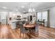 Well-lit open concept kitchen with seating, dining, and elegant light fixture at 307 Lanyard St, Johns Island, SC 29455