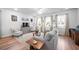 Bright living room with cozy seating, hardwood floors, and large windows with sheer curtains at 307 Lanyard St, Johns Island, SC 29455