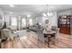 Spacious living room and dining area featuring elegant furnishings, hardwood floors, and a stylish chandelier at 307 Lanyard St, Johns Island, SC 29455