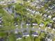 Community aerial view showcasing a neighborhood pond, green spaces, and well-spaced homes at 308 Burton Ave, Summerville, SC 29485