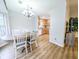 Bright dining room with wood floors, chandelier, and an adjacent kitchen at 308 Burton Ave, Summerville, SC 29485