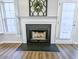 Close-up of a fireplace with a black mantel and hearth, adding character to the living space at 308 Burton Ave, Summerville, SC 29485