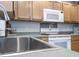 Kitchen showcasing a stainless steel sink, microwave, and light wood cabinets at 308 Burton Ave, Summerville, SC 29485