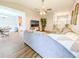 Open living space with hardwood floors, a gray sectional sofa, and an adjoining dining area at 308 Burton Ave, Summerville, SC 29485