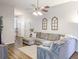 Spacious living area featuring modern decor, hardwood flooring and a large gray sectional sofa at 308 Burton Ave, Summerville, SC 29485