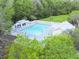 Aerial view of a community pool surrounded by lounge chairs and a wooded landscape at 308 Burton Ave, Summerville, SC 29485