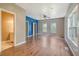 Bright bedroom with wood-look floors, ceiling fan, and ample natural light from the windows at 3143 Bonanza Rd, Charleston, SC 29414