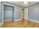 Bedroom with hardwood floors, grey walls, closet, ceiling fan and door to another room at 3143 Bonanza Rd, Charleston, SC 29414