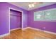 Bright purple bedroom with wood floors, fan and closet space near a window at 3143 Bonanza Rd, Charleston, SC 29414