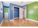 Bedroom with green and blue walls, hardwood floors, closet and connection to bath at 3143 Bonanza Rd, Charleston, SC 29414