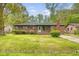 Charming brick home with a well-kept front lawn and beautiful landscaping at 3143 Bonanza Rd, Charleston, SC 29414