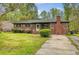 Well-maintained brick home featuring a front lawn, and mature landscaping at 3143 Bonanza Rd, Charleston, SC 29414