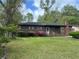 Attractive brick home boasting a lush green lawn and mature trees, offering a serene curb appeal at 3143 Bonanza Rd, Charleston, SC 29414