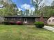 Charming brick home featuring a well-maintained front yard with blooming bushes and classic architectural details at 3143 Bonanza Rd, Charleston, SC 29414