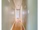 Long hallway with hardwood floors and multiple doorways leading to other rooms at 3143 Bonanza Rd, Charleston, SC 29414