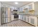 Well-lit kitchen featuring stainless steel appliances, modern backsplash, and laminate floors at 3143 Bonanza Rd, Charleston, SC 29414