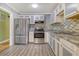 Kitchen features stainless steel appliances, mosaic tile backsplash, and new cabinets at 3143 Bonanza Rd, Charleston, SC 29414