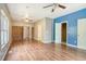 Open living area with wood floors, ceiling fans, and brick wall at 3143 Bonanza Rd, Charleston, SC 29414