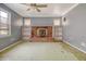 Living room with brick fireplace, shelving units, and natural light at 3143 Bonanza Rd, Charleston, SC 29414