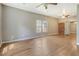 Image shows an empty living room with hardwood floors and brick accents at 3143 Bonanza Rd, Charleston, SC 29414
