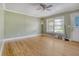 Bright living room features hardwood floors, large window, and ceiling fan at 3143 Bonanza Rd, Charleston, SC 29414