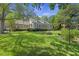 Spacious backyard featuring lush green lawn, a cozy fire pit and an inviting patio at 3168 Stanyarne Dr, Charleston, SC 29414