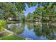 Backyard with a view of a lake, surrounded by lush greenery and trees, offering privacy and a serene atmosphere at 3168 Stanyarne Dr, Charleston, SC 29414