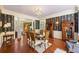 Elegant dining room boasts hardwood floors, striking wallpaper, and stylish chandelier lighting at 3168 Stanyarne Dr, Charleston, SC 29414