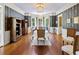 Charming dining room features a bay window, hardwood floors, and elegant chandelier at 3168 Stanyarne Dr, Charleston, SC 29414