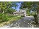 Exterior shot of a house with a long driveway and mature landscaping at 3168 Stanyarne Dr, Charleston, SC 29414