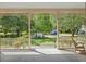 Inviting covered front porch with rocking chair overlooking the lush green front yard at 3168 Stanyarne Dr, Charleston, SC 29414