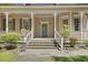Inviting front porch with decorative columns and a charming blue door at 3168 Stanyarne Dr, Charleston, SC 29414