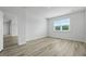 Bright bedroom with natural light from a large window and modern wood-look flooring at 323 Blue Haw Dr, Moncks Corner, SC 29461