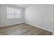 Sunlit bedroom with a window and wood-look flooring creating a cozy and inviting atmosphere at 323 Blue Haw Dr, Moncks Corner, SC 29461