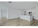 Open-concept kitchen with white cabinets, stainless steel appliances, and laminate flooring throughout at 323 Blue Haw Dr, Moncks Corner, SC 29461